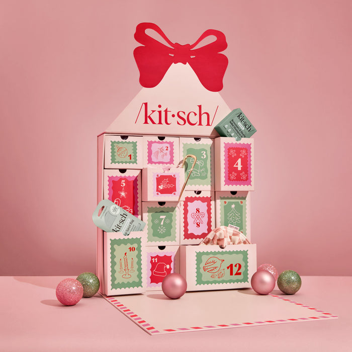 Kitsch advent calendar with pink, red, and green design on a pink background