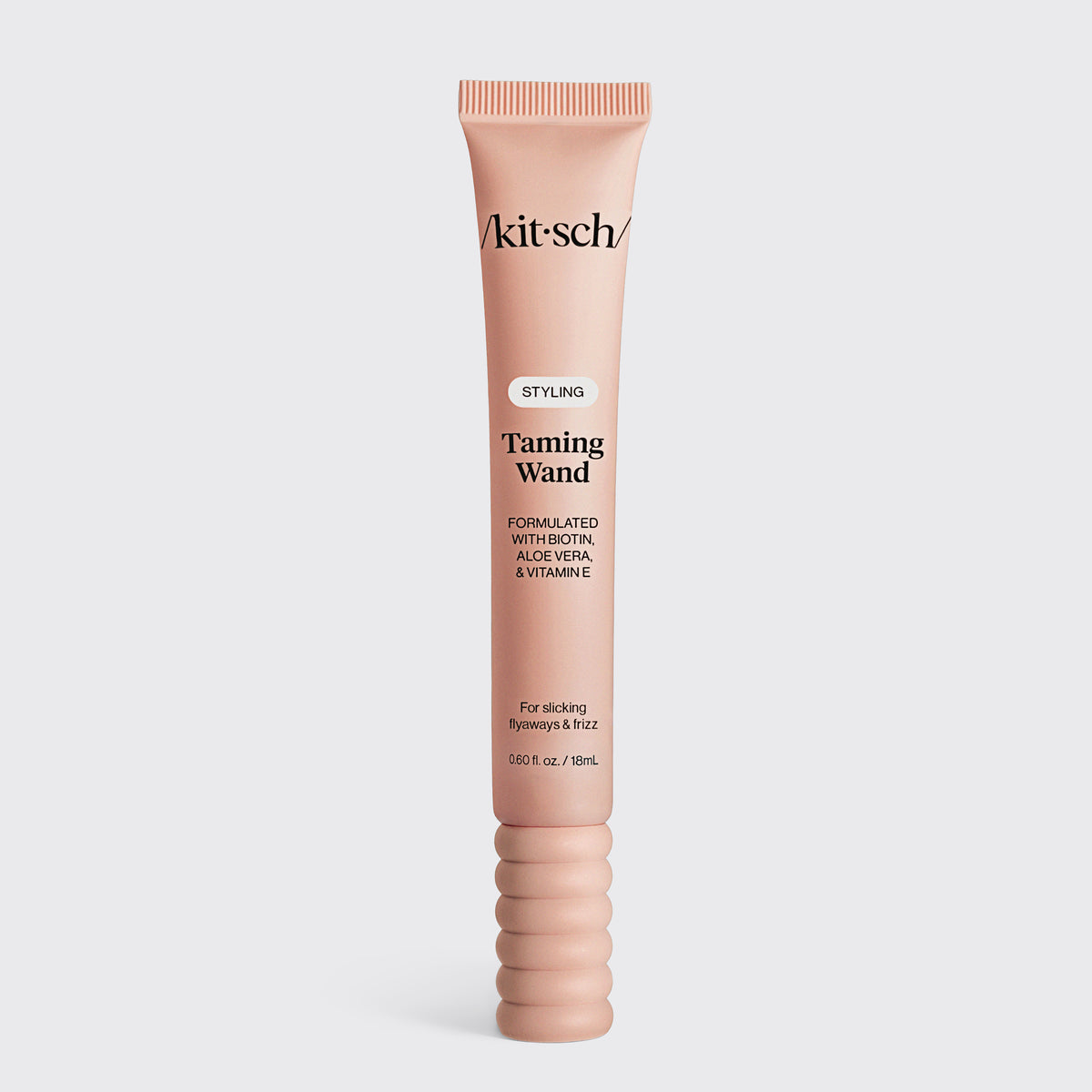 KITSCH Styling Taming Wand — hero product shot of the pink tube standing alone on a light gray background — enriched with nourishing biotin, aloe vera, and vitamin E for added hydration — compact packaging makes it easy to style on the go