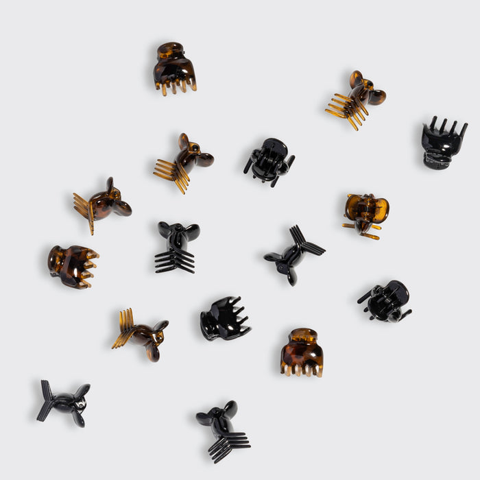 Collection Kitsch Black & Tort Micro Cloud Clips scattered on a light grey background