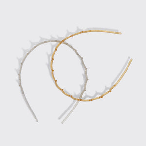 KITSCH Gold & Silver Zig Zag Headbands 2pc Set — the silver and gold zigzag headbands crossed on a grey background — Helps tame flyaways and loose strands — choosing between the two finishes