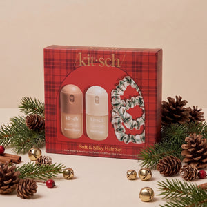 KITSCH Soft & Silky Hair 4pc Set — red plaid gift box with the Amber Shores and Warm Sugar mini hair perfumes and ivory, red and green plaid satin scrunchies, styled with pine branches, pinecones, cinnamon sticks, red berries and gold jingle bells on a cream backdrop — the season's cutest accessories — find a little something special for everyone on your list