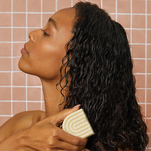 KITSCH Coconut Oil Conditioner Bar for Dry Damaged Hair — model using deep moisturizing coconut oil conditioner bar — helps restore softness & shine for less damage, breakage, and hair loss over time — made in the USA, vegan, cruelty-free & Leaping Bunny Certified