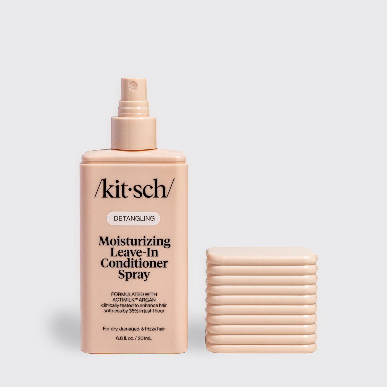 Moisturizing Leave-In Conditioner Spray with the cap removed, showcasing the spray applicator and sustainable refillable packaging.