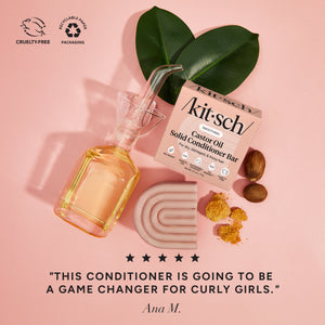 KITSCH Castor Oil Nourishing Conditioner Bar — ingredient flat lay on pink background with castor oil bottle, bar, castor seeds, and tropical leaves — 5-star review: THIS CONDITIONER IS GOING TO BE A GAME CHANGER FOR CURLY GIRLS. — Ana M. — Cruelty-Free | Recyclable Paper Packaging — Deeply nourishes dry & damaged hair for stronger, hydrated-looking strands