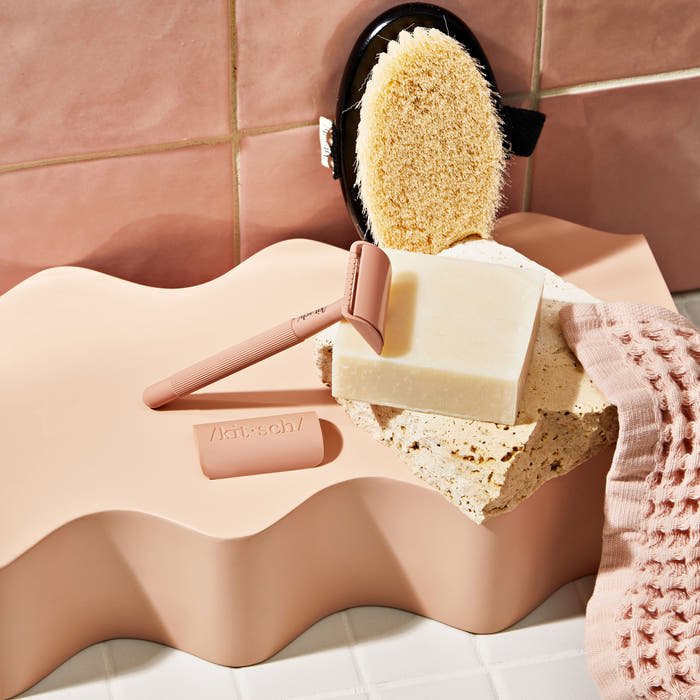 KITSCH Solid Shave Butter — model applying shave butter to leg — Hydrating, buttery formula works to cushion your shave while nourishing your skin — reduces single-use plastic: saves two bottles of shaving cream